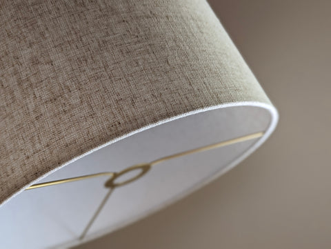 Close-up of a textured lampshade in tan with euro fitter hardware