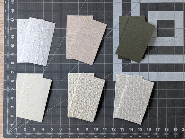 Fabric swatches on a cutting mat with measurements