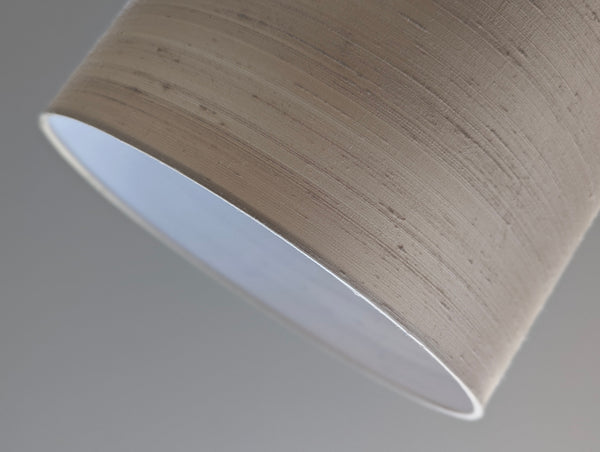 Close-up of a silk lampshade on a plain background