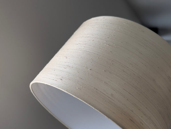Close-up of a beige lampshade on a gray background
