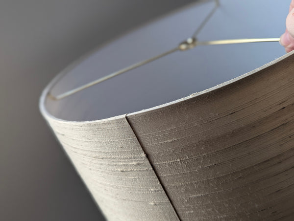 Close-up of a textured lampshade with a blurred background