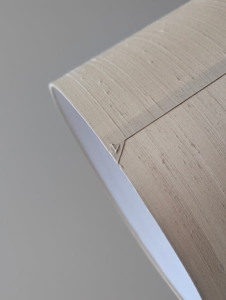 Close-up of a lampshade with a triangle on the back seam 