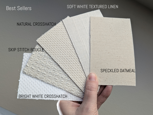 Hand holding fabric swatches labeled with different textures and names.