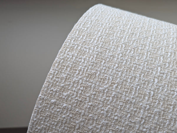 mid-mod boucle fabric lamp shade close up with spider washer hardware