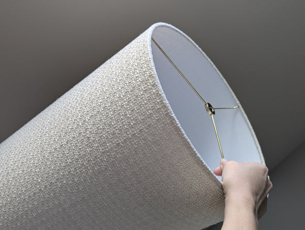 mid-mod boucle fabric lamp shade close up with spider washer hardware