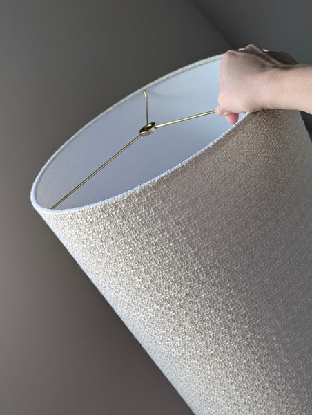 mid-mod boucle fabric lamp shade close up with spider washer hardware