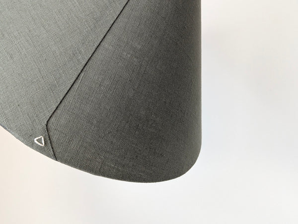close up of the back seam of the cone lamp shade in olive green linen with a triangle stitch detail in ecru