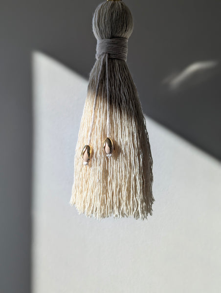 Tassel with decorative elements on a gray background