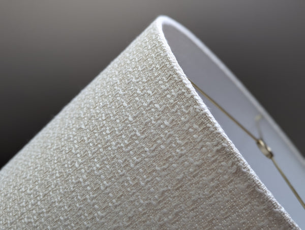 mid-mod boucle fabric lamp shade close up with spider washer hardware