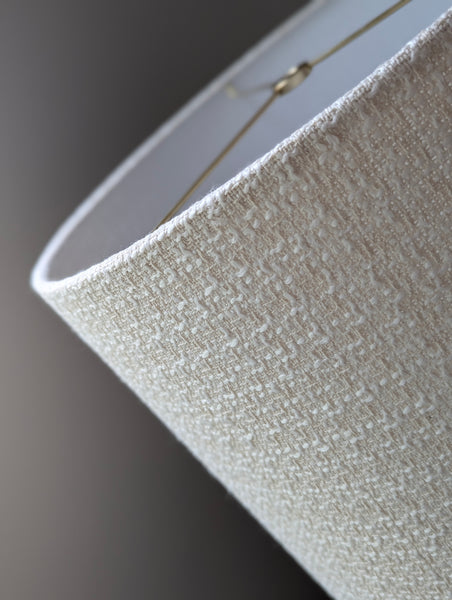 mid-mod boucle fabric lamp shade close up with spider washer hardware