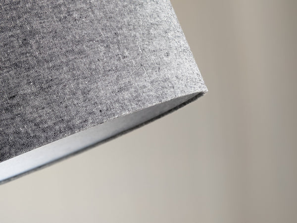 Close-up of a textured gray lamp shade with a wrapped edge