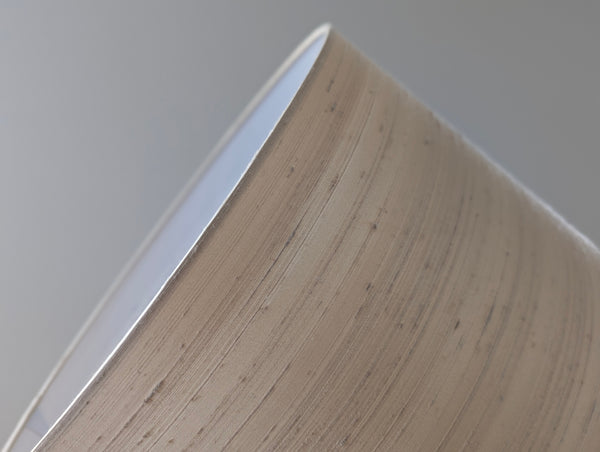 Close-up of a silk lamp shade on a neutral background