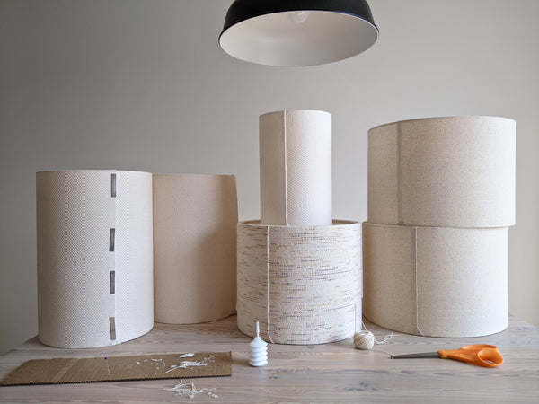 group of lampshades on a work table