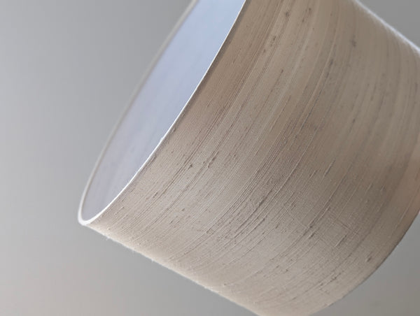 Close-up of a dupioni silk lamp shade  on a gray background