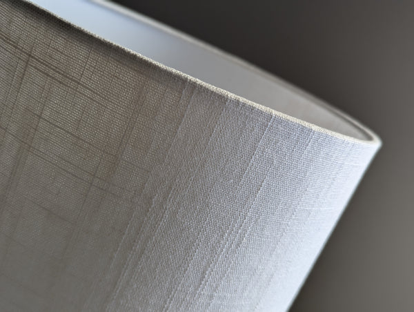 Close-up of a drum lampshade made of white linen fabric