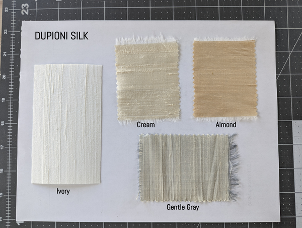 Fabric swatches labeled with colors and names on a white card, 'Ivory, Cream, Almond, Gentle Gray'