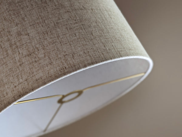 Close-up of a textured lampshade in tan with euro fitter hardware