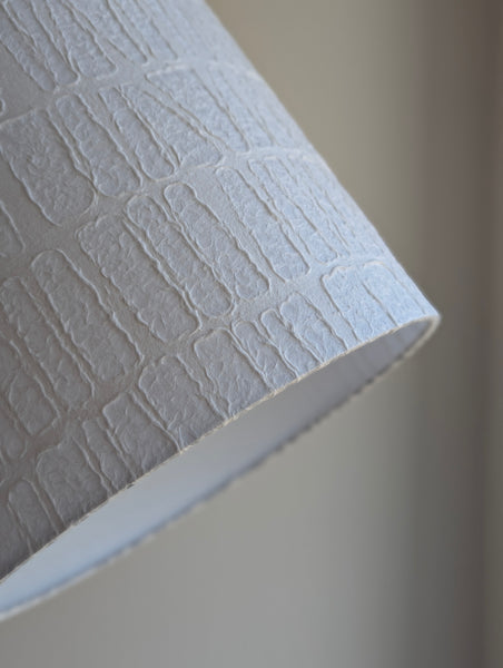 white textured paper lamp shade with geometric pattern 