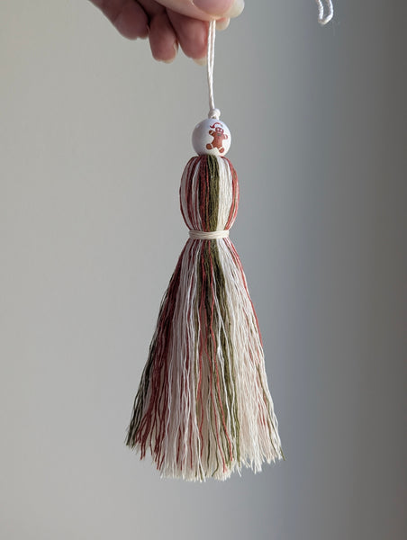 holiday tassel gift tag in red and green with a gingerbread man bead at the top