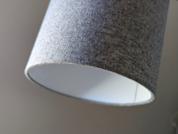 close up of the bottom of the narrower side of oval lampshade in black and white fabric