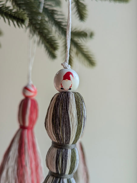 Decorative hanging tassel ornament with a gnome in a red hat design 