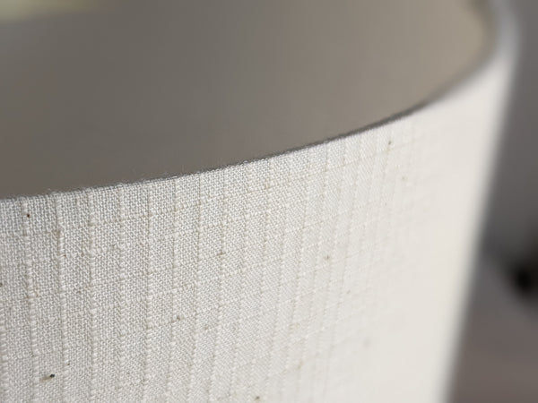 Close-up of a cream textured fabric lampshade in Grid Ecru fabric