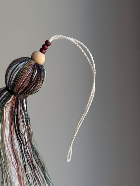 red and green holiday tassel door hanger with cranberry red wooden beads