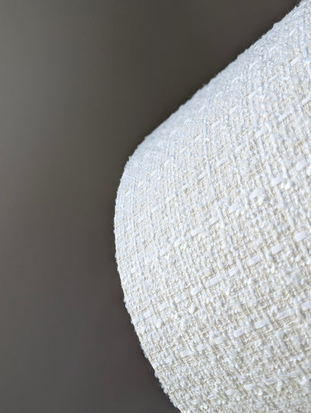 Close-up of a tweed boucle lamp shade showing the different fibers in the fabric 