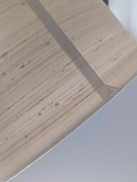 close up of a lamp shade with a triangle on the back seam
