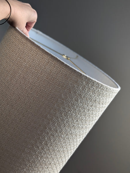 mid-mod boucle fabric lamp shade close up with spider washer hardware