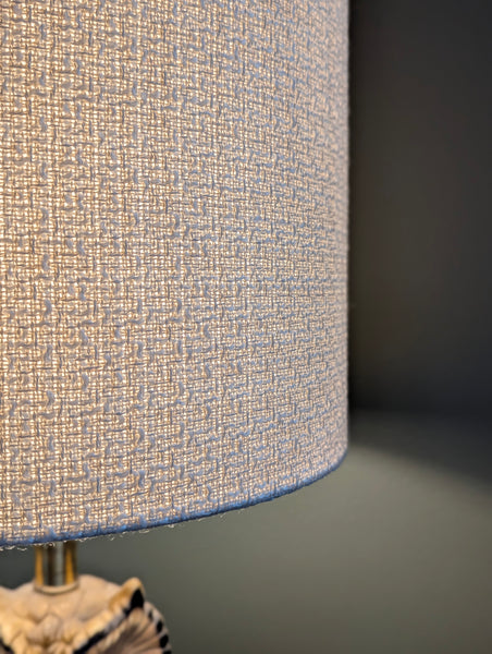 mid-mod boucle fabric lamp shade close up with spider washer hardware