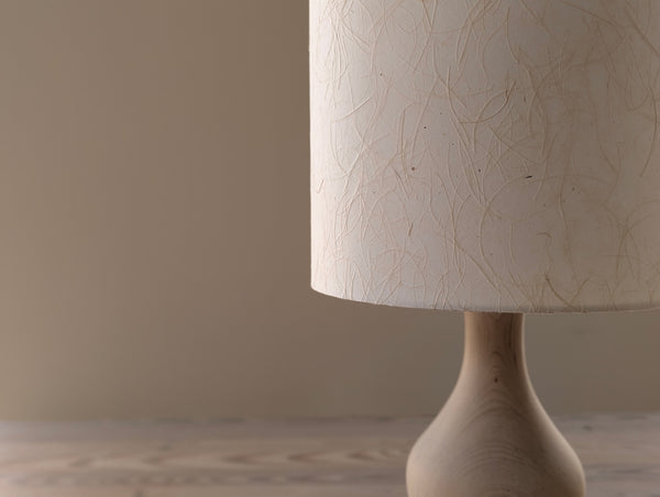 mulberry paper lampshade with textured paper in cream color on a wooden lamp