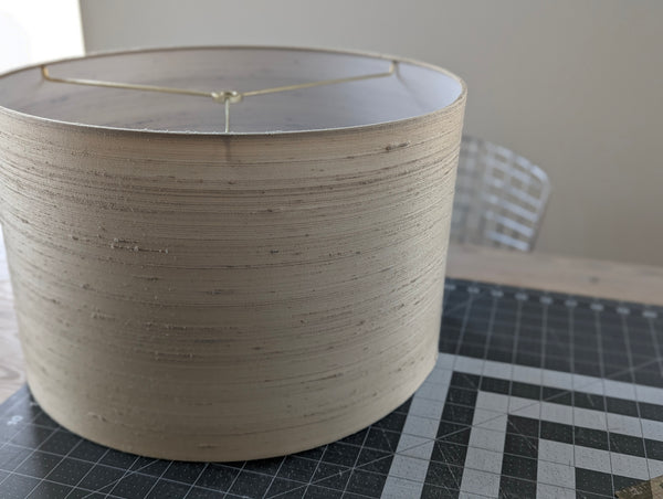 beige drum lamp shade on a cutting mat