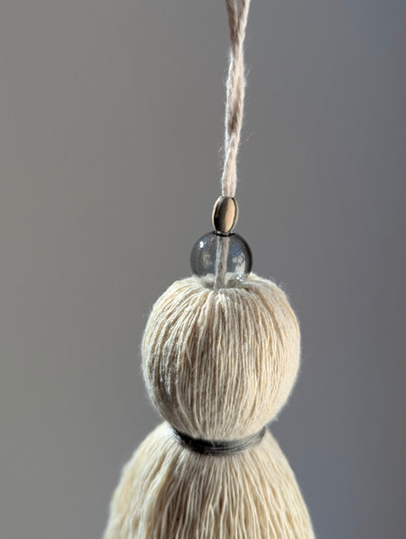 Tassel with a neutral color scheme on a gray background