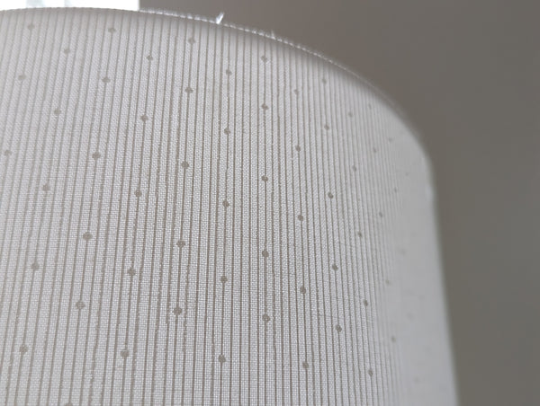 close up of white lamp shade with stripes and polka dots 