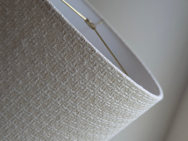 mid-mod boucle fabric lamp shade close up with spider washer hardware