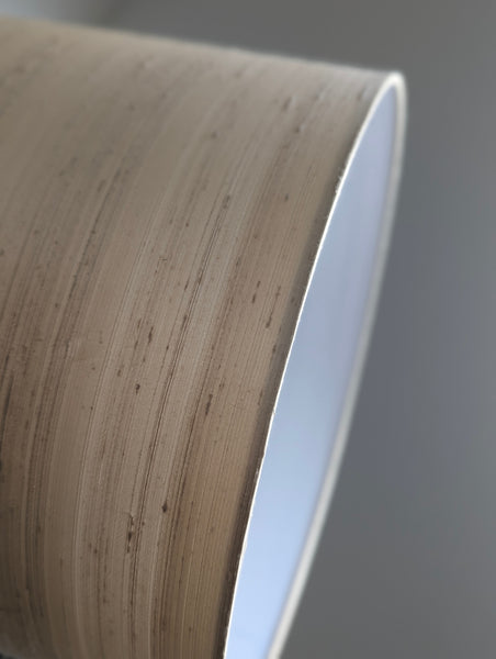 Close-up of a textured silk lampshade  against a neutral background