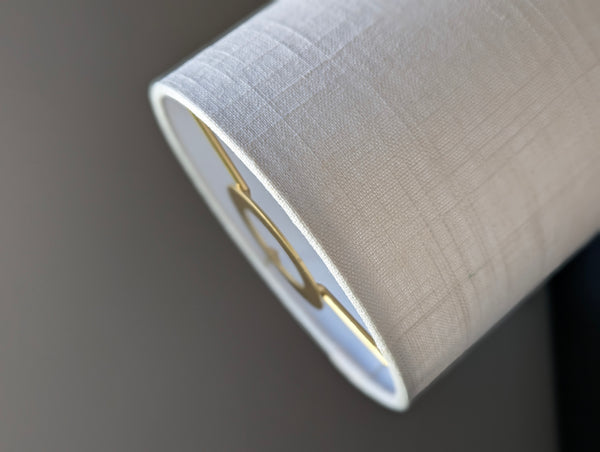 Close-up of a drum lampshade made of white linen fabric with euro fitter hardware
