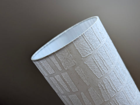 white textured paper lamp shade with geometric pattern 