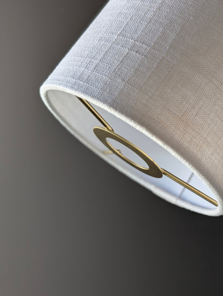 Close-up of a drum lampshade made of white linen fabric with euro fitter hardware