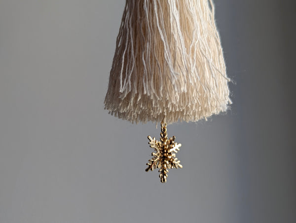 snowy white snowflake tassel with white speckled glass bead and brass snowflake charm