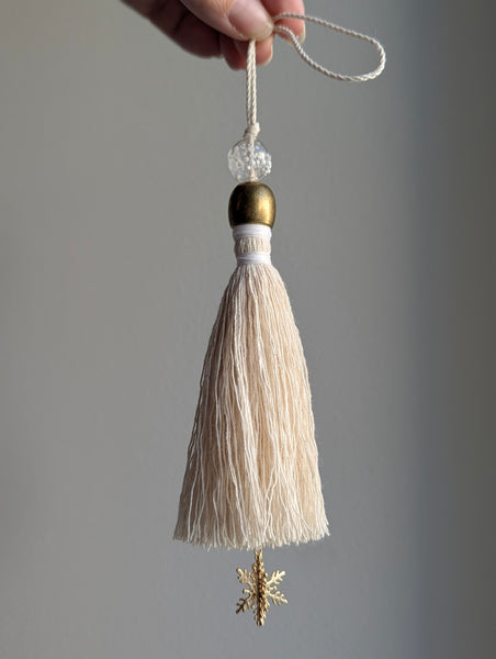 snowy white snowflake tassel with white speckled glass bead and brass snowflake charm