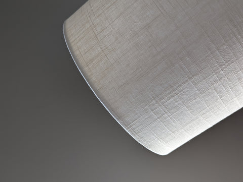 Close-up of a drum lampshade made of white linen fabric