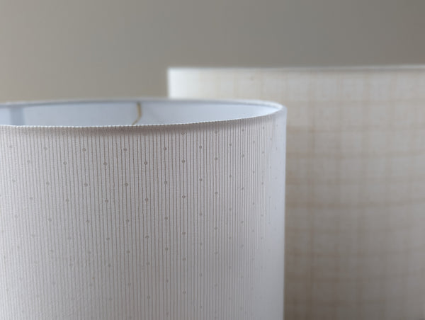 hidden dot fabric lamp shade next to windowpane ecru lamp shade by ud form