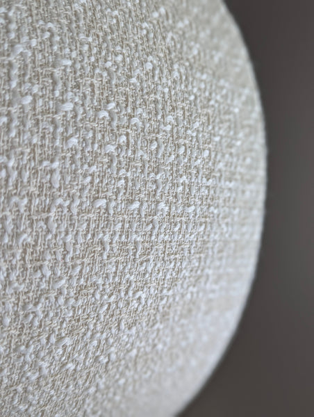 mid-mod boucle fabric lamp shade close up with spider washer hardware