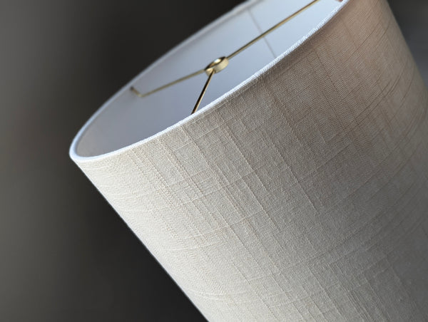 Close-up of a drum lampshade made of white linen fabric with spider washer hardware