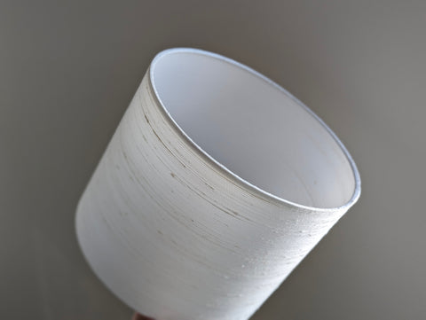 A close-up of a white silk lampshade 