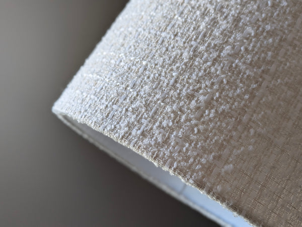 Close-up of a textured boucle lamp shade with a blurred background