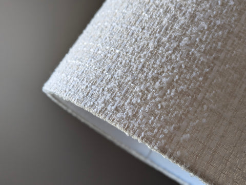 Close-up of a textured boucle lamp shade with a blurred background