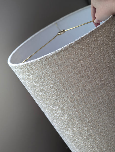 mid-mod boucle fabric lamp shade close up with spider washer hardware